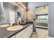 A cozy bathroom with a large vanity and a glimpse into the bedroom area at 10987 Cannonade Dr, Parker, CO 80138