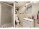 Compact bathroom featuring a walk-in shower, toilet, vanity with sink, and a mirror at 10987 Cannonade Dr, Parker, CO 80138