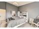 Comfortable bedroom with a walk-in closet and private bathroom, decorated in neutral grays at 10987 Cannonade Dr, Parker, CO 80138