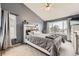 Comfortable bedroom with a large window, gray walls, and ceiling fan at 10987 Cannonade Dr, Parker, CO 80138