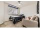 This bedroom features a bed, ceiling fan, and window that provides natural light at 10987 Cannonade Dr, Parker, CO 80138