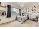 Charming bedroom featuring unique wall decor, a chandelier, and a well-lit desk area at 10987 Cannonade Dr, Parker, CO 80138