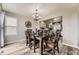 Comfortable dining area adjacent to the kitchen, featuring a chandelier and modern accents at 10987 Cannonade Dr, Parker, CO 80138