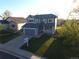Charming two-story blue home with a well-manicured lawn and a welcoming front porch at 10987 Cannonade Dr, Parker, CO 80138