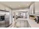 Open-concept kitchen with stainless steel refrigerator and view to dining area at 10987 Cannonade Dr, Parker, CO 80138
