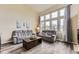 Bright living room with large windows, wood floors and comfortable seating at 10987 Cannonade Dr, Parker, CO 80138
