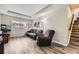 Inviting living room with wood floors, natural light, and stairs that lead to the second floor at 10987 Cannonade Dr, Parker, CO 80138