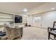 Finished basement featuring built-in shelves, carpet floors, and a cozy chair at 10987 Cannonade Dr, Parker, CO 80138
