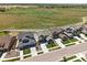 Aerial view of homes with green lawns and open space in the distance at 740 Meadowlark Dr, Erie, CO 80516