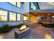 Backyard featuring a fire pit and hot tub under covered patio, perfect for relaxation and outdoor gatherings at 740 Meadowlark Dr, Erie, CO 80516