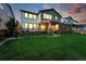 Spacious backyard featuring a lush green lawn and a covered patio, perfect for outdoor relaxation and entertaining at 740 Meadowlark Dr, Erie, CO 80516