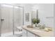 Clean bathroom features a sleek glass shower, modern fixtures, and a vanity with ample counter space and storage at 740 Meadowlark Dr, Erie, CO 80516