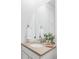Bathroom vanity featuring neutral countertops, white cabinets, and modern fixtures at 740 Meadowlark Dr, Erie, CO 80516