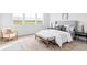 Bedroom with white walls and a large window overlooking a scenic view and stylish furniture at 740 Meadowlark Dr, Erie, CO 80516