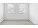 Bright bedroom featuring large windows allowing for ample natural light and neighborhood views at 740 Meadowlark Dr, Erie, CO 80516