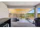 Relaxing covered patio featuring a hot tub, wooden privacy fence, and an infrared heater at 740 Meadowlark Dr, Erie, CO 80516