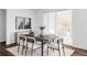 Bright dining room featuring a wood table with seating for six, sliding glass doors, and stylish decor at 740 Meadowlark Dr, Erie, CO 80516