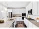 Spacious kitchen with an island, modern appliances, ample cabinetry, and hardwood floors at 740 Meadowlark Dr, Erie, CO 80516