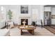 Cozy living room featuring a stone fireplace, modern decor, and lots of natural light at 740 Meadowlark Dr, Erie, CO 80516