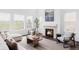 Bright living room with fireplace, hardwood floors, modern furniture, and large windows with views at 740 Meadowlark Dr, Erie, CO 80516