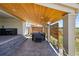 Covered patio area with a hot tub, stone steps, and a view of the surrounding landscape at 740 Meadowlark Dr, Erie, CO 80516