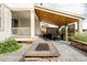 Inviting patio with a stone fire pit, hot tub, and wood-covered ceiling at 740 Meadowlark Dr, Erie, CO 80516