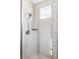 Modern bathroom shower with light tile, a rainfall showerhead, and a built-in shelf for toiletries at 740 Meadowlark Dr, Erie, CO 80516