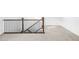 Carpeted staircase with dark wood handrail and modern iron balusters provides a safe and stylish transition between floors at 740 Meadowlark Dr, Erie, CO 80516