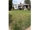 Landscaped front yard with a white house featuring a covered outdoor seating area and manicured bushes at 4780 Milwaukee St, Denver, CO 80216