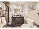 Neutral bathroom featuring a dark wood vanity with black countertop and tiled walk-in shower at 4780 Milwaukee St, Denver, CO 80216