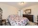 Bedroom featuring floral bedding, carpet and adjacent door at 4780 Milwaukee St, Denver, CO 80216