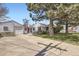 Exterior view of a house featuring a detached garage and a well-maintained front yard at 4780 Milwaukee St, Denver, CO 80216