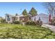 Landscaped backyard featuring a gazebo, patio, and detached garage at 4780 Milwaukee St, Denver, CO 80216