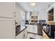 Bright kitchen with stainless dishwasher and white cabinets offering ample storage at 4780 Milwaukee St, Denver, CO 80216