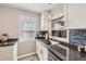 Kitchen features stainless sink and blue tiled backsplash with light grey paint at 4780 Milwaukee St, Denver, CO 80216