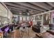Finished basement living area featuring exposed ceiling, brick fireplace and leather furniture at 4780 Milwaukee St, Denver, CO 80216
