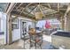 Covered patio featuring a dining table, grill, and cozy ambiance at 4780 Milwaukee St, Denver, CO 80216