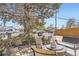 Outdoor patio area with wrought iron furniture, mature tree, and privacy fencing at 4780 Milwaukee St, Denver, CO 80216