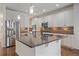 Kitchen with island, stainless steel appliances, and hardwood floors at 3914 Donnington Way, Castle Rock, CO 80104