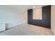 Bright bedroom with carpeted floors and black cabinetry providing ample storage space at 888 N Logan St # 4A, Denver, CO 80203
