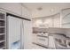 Well-lit kitchen featuring white cabinets and modern appliances at 888 N Logan St # 4A, Denver, CO 80203