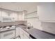Compact kitchen with modern appliances, white cabinets, and ample counter space at 888 N Logan St # 4A, Denver, CO 80203