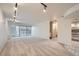 Spacious living room with balcony access, track lighting, and an adjacent kitchen area at 888 N Logan St # 4A, Denver, CO 80203