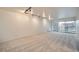 Bright living room with neutral carpet, track lighting, and sliding glass doors to the balcony at 888 N Logan St # 4A, Denver, CO 80203