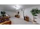 Finished basement with carpet, cozy seating, a television and a large tree in the corner at 663 S Xenon Ct, Lakewood, CO 80228
