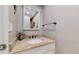Half bathroom features granite countertops and decorative mirror above the sink at 663 S Xenon Ct, Lakewood, CO 80228