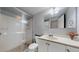 Modern bathroom featuring a walk-in shower and a vanity with sink at 663 S Xenon Ct, Lakewood, CO 80228