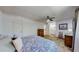 Bedroom with view to bathroom, paisley bedding, side table, lamp and wood dresser at 663 S Xenon Ct, Lakewood, CO 80228
