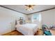 Cozy bedroom featuring a double bed, patterned wallpaper, and a ceiling fan at 663 S Xenon Ct, Lakewood, CO 80228