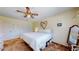 Bedroom featuring a ceiling fan, large closet, and comfortable king-sized bed for rest and relaxation at 663 S Xenon Ct, Lakewood, CO 80228